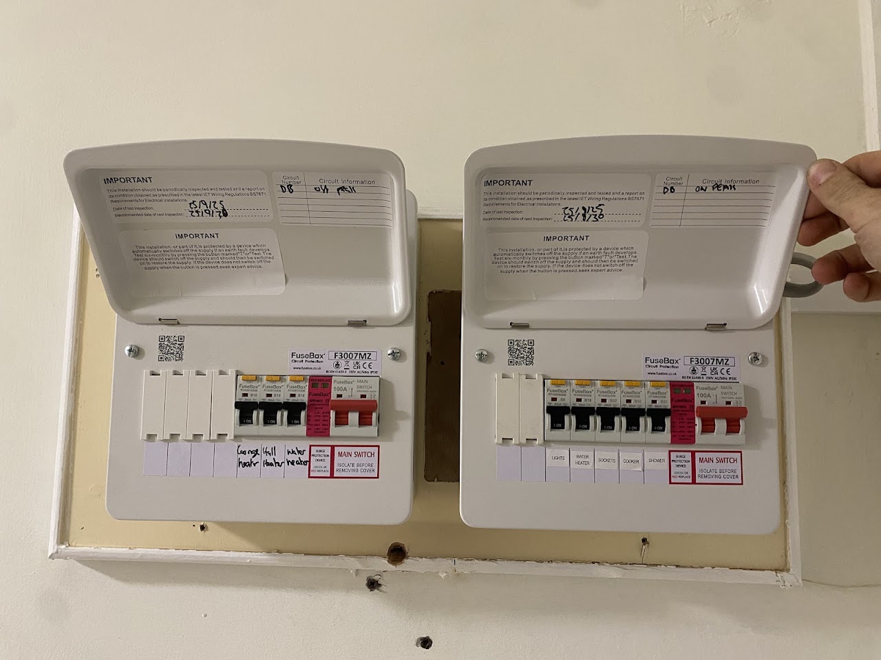 Two new consumer units fitted side by side, neatly wired and labelled