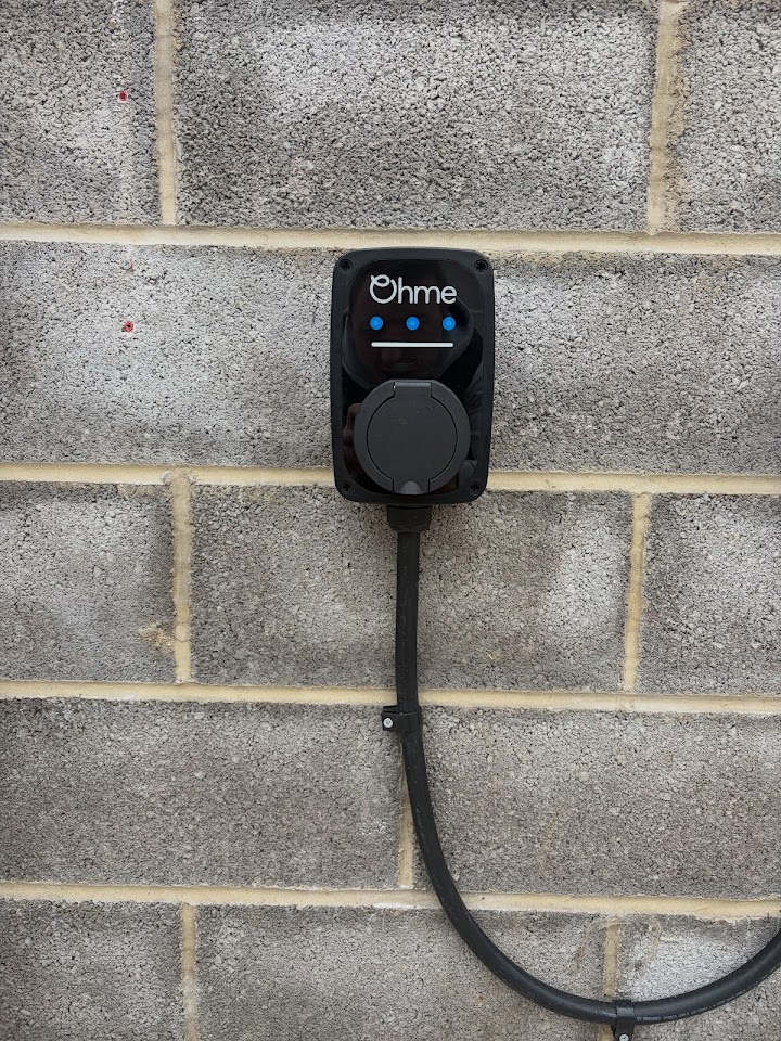 Ohme EV charger installed on the outside wall of a Bristol home